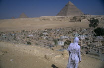 The Pyramids with man standing in front of Muslim graveyard