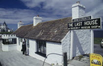 Woman standing outside The Last House of the Most Northern point of Mainland Britain
