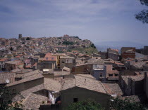 View East over the rooftops of the hilltop city towards Mount Etna