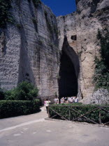 Latomie stone quarries caves  also used for prisons. Tourists at the entrance to The Ear of Dionysius  Orecchio di Dionisio