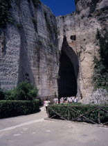 Latomie stone quarries caves  also used for prisons. Tourists at the entrance to The Ear of Dionysius  Orecchio di Dionisio