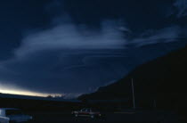 Mount St Helens Volcanic eruption 1980 at 8.55am. View from car park next to buildings towards ash falling from forest covered mountain in dark light  In 1982 the President and Congress created the 1...