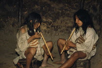 Men playing  kuisi  flutes in San Miguel village.  macho  male flute has one hole and player waves a maraca;  embra  female flute which has five holes and maintains the melody.Indigenous Tribes  Amer...