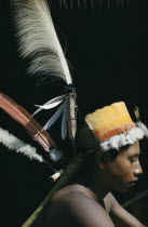 Portrait of Uriel  young man with fine feather head-dress of royal crane  macaw  toucan and egret feathers. Note feathers are woven into the head-dress with  cumare  fibre and attached to a banana ste...
