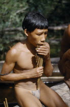 Boy playing the  carizu  / panpipes at the maloca s river port on the rio PiraparanaTukano / Makuna       Indigenous Tribes  rio Piraparana North West Amazonia Amazon American Colombian South America...