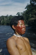 Portrait of Marco  a hunter with red  karajuru  facial paint  wooden ear-plug and strings of precious white and pale blue glass beads  traded throughout Amazonia Indigenous Tribes  rio Piraparana Nor...