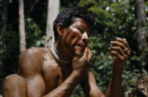 Man applies  karajuru  / facial paint before he goes huntingIndigenous Tribes  rio Piraparana North West Amazonia Amazon American Colombian South America Vuapes Columbia Hispanic Indegent Latin Ameri...