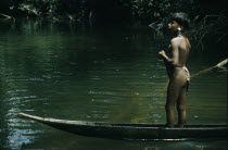Ricardino  a young boy with a silver ear plug paddles his canoe upstream towards the family cultivation plotThe Noanama are a minority group of approximately 3000 Indians. The Noanama live in an are...