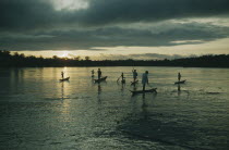 Boys paddling canoes on lower rio San Juan at duskThe Noanama are a minority group of approximately 3000 Indians. The Noanama live in an area on the Pacific coast of Colombia which is known as the Ch...