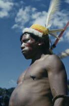 Man with ceremonial feather head-dress  crown of white egret down  macaw and toucan breast feathers  royal crane and macaw tail feathers; forest nut arm band  red  ochote  berry facial paintAmazon I...