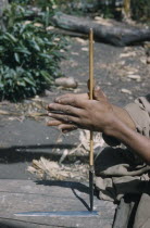 Man drills hole in base of steel arrow-head for attachment to bamboo shaftIndigenous Tribes American Colombian South America Columbia Hispanic Indegent Latin America Latino Male Men Guy