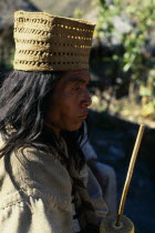 Parque Nacional. Kogi mama/priest Juan Vacuna wearing a woven fique/cactus fibre hat  holding a lime-encrusted poporo/gourd  with a palito/stick used to transfer lime powder out of the gourd and into...