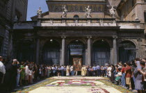 Santa Maria in Trastevere Basilica with crowds gathered for display of icon and flower petal mosaic during Infiorata di Gerano.