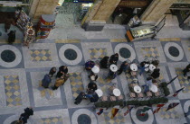 Looking down on cafe tables inside Galleria Umberto.