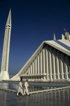 Worshippers walking past the pool at the Shah Faisal mosque