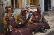 Monk musicians sat playing in the Barkhor Bazaar.
