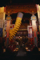 Monks chanting in the main chapel of Gonggar Chode Monastery near Lhasa Airport.