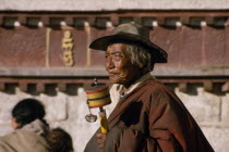 An elderly pilgrim with prayer wheel in the Barkhor Bazaar