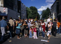 Notting Hill carnival multicultural group of parade onlookers.Nottinghill
