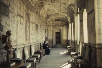Vatican City.  Nuns in waiting room decorated with frescoes by Raphael.