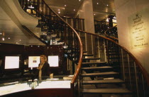 Interior of jewellery shop on Rue du Rhone with sales assistant standing behind display counter. Store