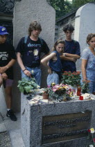 Pere Lachaise Cemetery. Visitors surrounding Jim Morrison s GraveJames