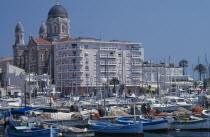 Town buildings and port with yachts moored on water