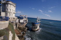 Nice. Cap de Nice. Diving port built on rocks along coastline next to La Reserve building