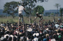 Bapende stiltwalkers amongst crowd at Gungu festival. Zaire
