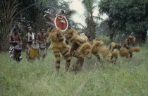 Bapende animal masqueraders performing dance at initiation ceremony. Zaire