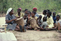 Nun teaching children to play drums in mission school.