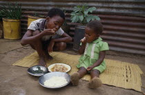 Children eating meal using right hands. Kwazulu Natal