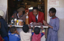 Children at spaza shop.  Meaning camouflage  spaza was the name given to house shops  the only way for black South Africans to set up business in apartheid eraThe Land Acts  Group Areas Act and Urban...