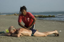 Tourist receiving a massage on Boca Grande beach