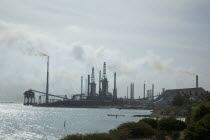 Valero refinery including flare stack  located on southern tip and capable of producing 275 000 barrels per day.