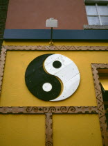 Yin and Yang symbol painted onto a wall. Yin Yang originates in ancient Chinese philosophy and metaphysics  which describes two primal opposing but complementary forces found in all things in the univ...