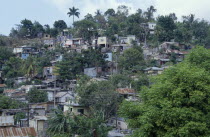 Overcrowded slum area  shanty housing on hillside with corrugated tin rooves.