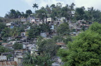Overcrowded slum area  shanty housing on hillside with corrugated tin rooves.