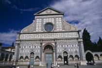 Santa Maria Novella exterior facade with geometric design and central circular window.