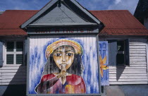 Roseau.  Mural on exterior of bread shop in the centre of the capital.