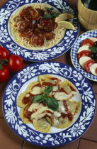 Spaghetti with clams  ravioli and Insalata Capresepasta  salad