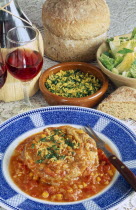 Ossobucco  a dish of braised shin of veal served with bread salad and red wine.