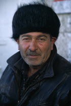 Man in fur hat.  Head and shoulders portrait.