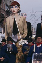 Woluwe St. Lambert  Spring Festival.  Parading bandsmen with giant figures in costume behind them.