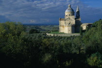 Italy, Tuscany, Montepulciano, Tempio di San Biagio, High Renaissance church with domed roof surrounded by trees.