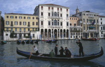 A Traghetti gondola taxi with passengers on the Grand Canal.