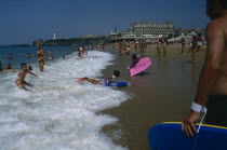 Biarritz.  Busy beach scene with children playing in the surf.