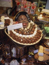 A shop display of an assortment of hand made chocolates