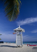 Lifeguard hut on sandy beach with American flag flying