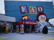 International Drive. Pointe Orlando Shopping Area. FAO Schwartz Toy Store chain colourful exterior with giant seated Raggedy Ann statue